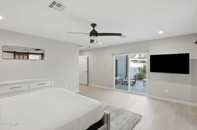 a bedroom with a bed and a flat screen tv