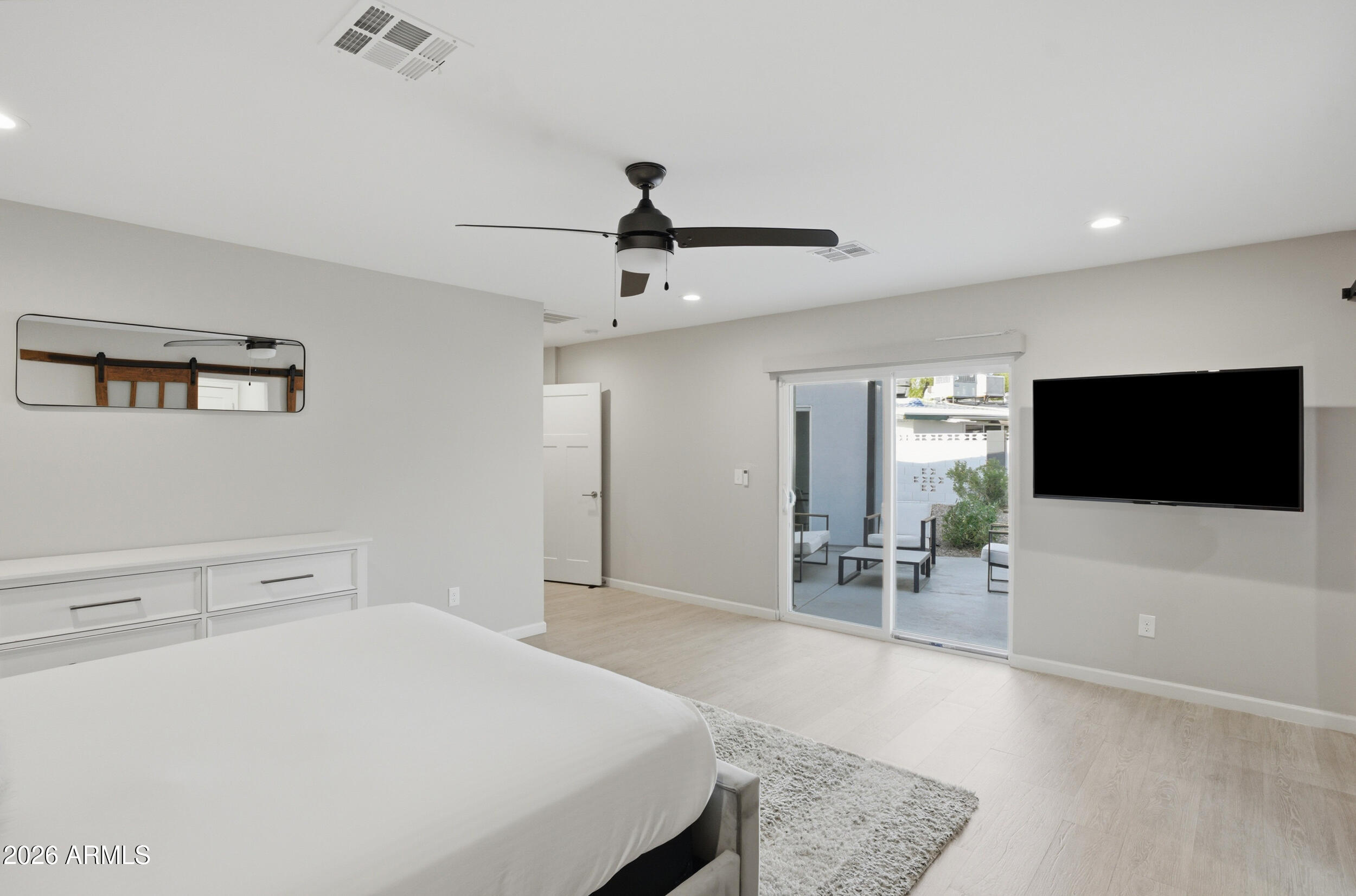 1134 East Colter Street Phoenix, AZ 85014 - Photo 10 of 27 a bedroom with a bed and a flat screen tv