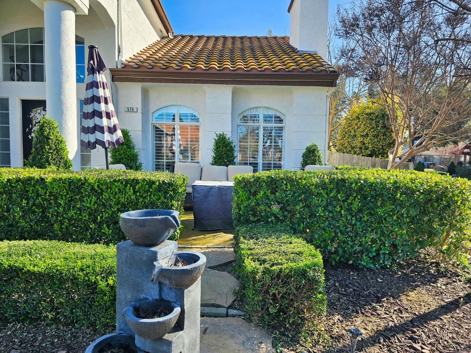 576 West Bedford Avenue Clovis, CA 93611 - Photo 3 of 79 a view of a house with backyard sitting area and garden