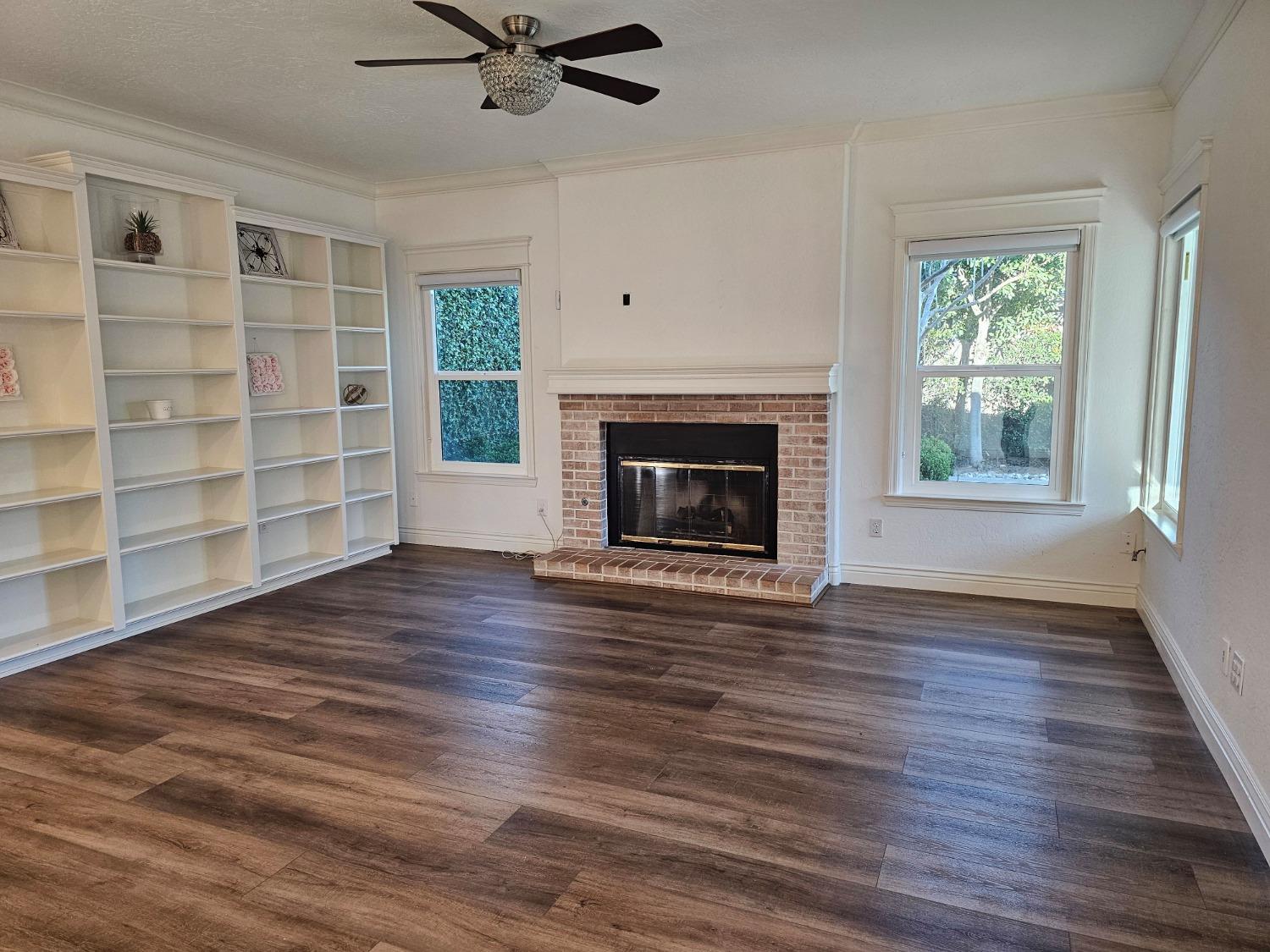 576 West Bedford Avenue Clovis, CA 93611 - Photo 35 of 79 wooden floor fireplace and windows in an empty room