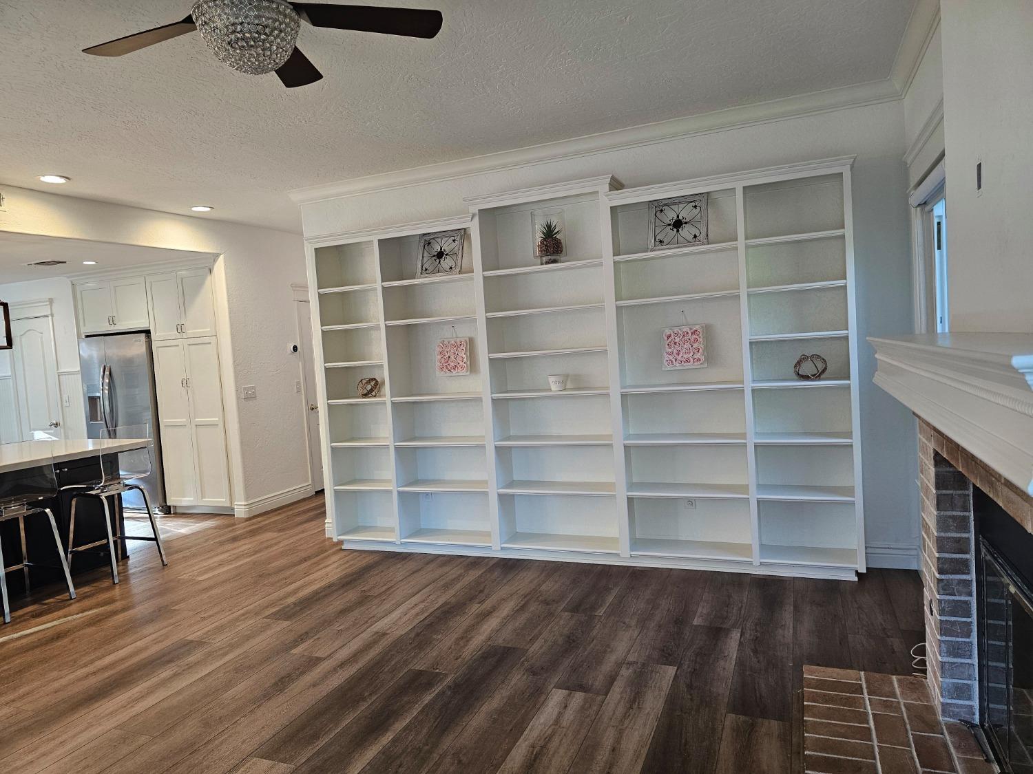 576 West Bedford Avenue Clovis, CA 93611 - Photo 39 of 79 a view of empty room with wooden floor and cabinet