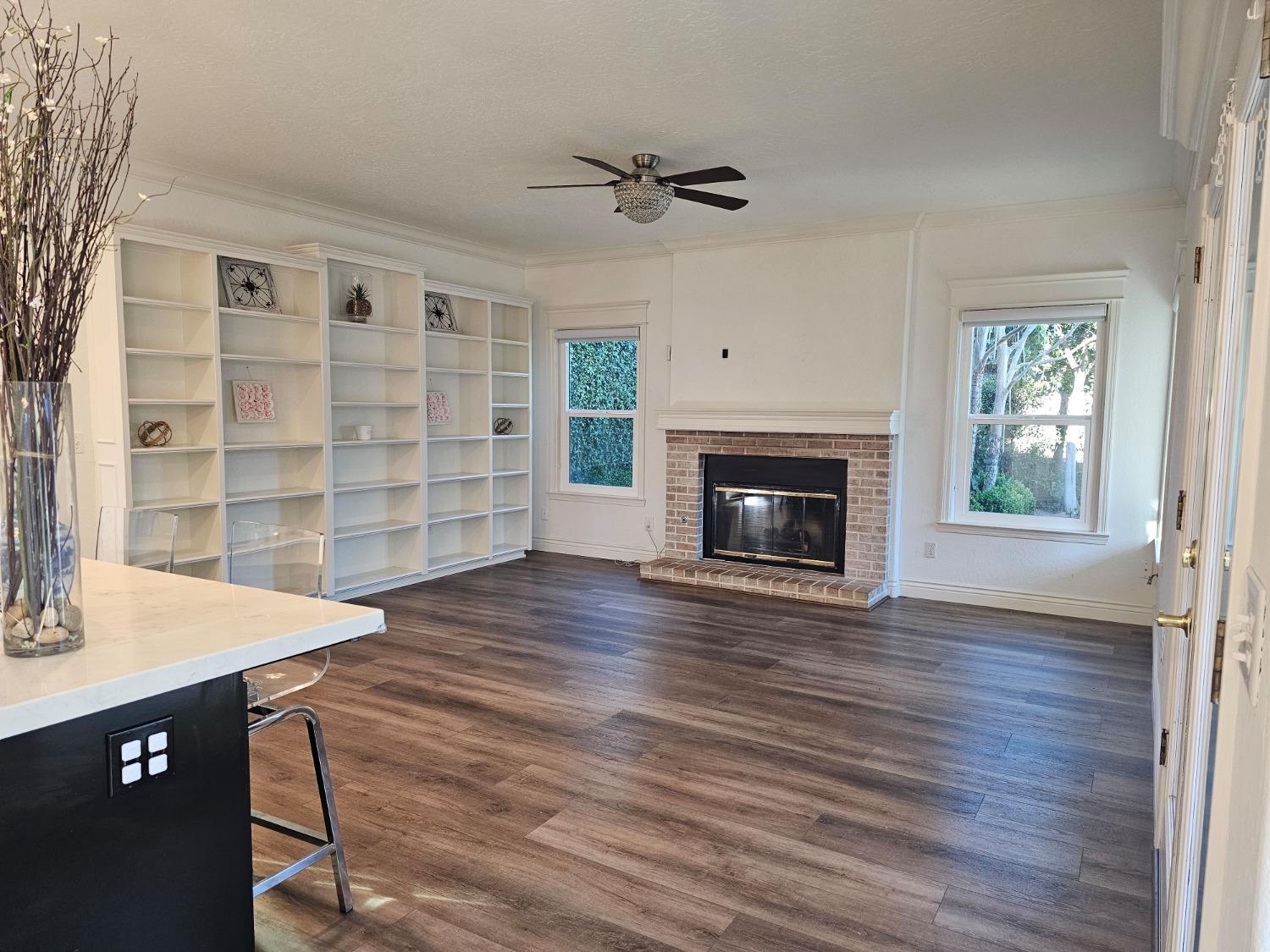 576 West Bedford Avenue Clovis, CA 93611 - Photo 40 of 79 a view of an empty room with a fireplace and a window