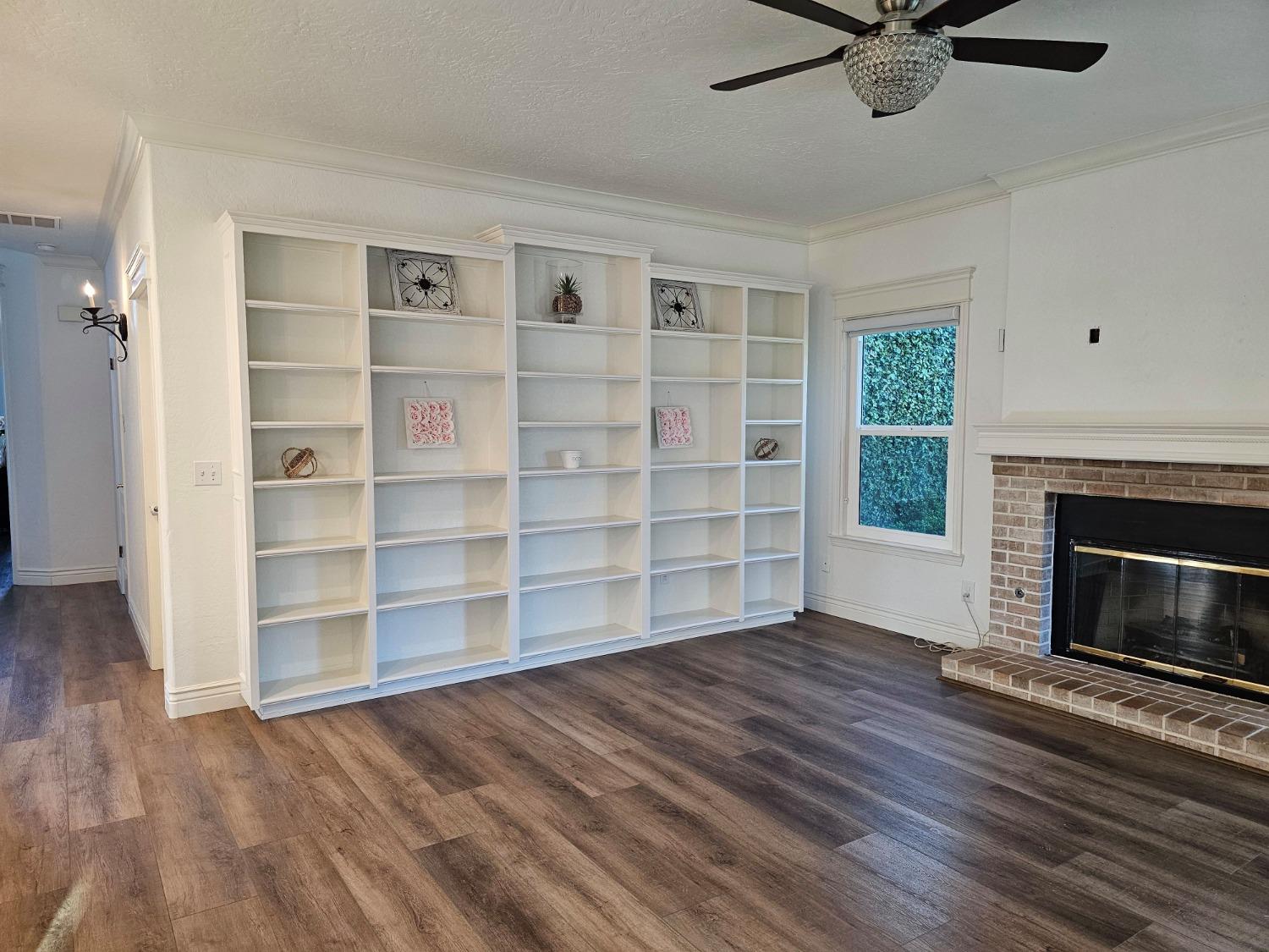 576 West Bedford Avenue Clovis, CA 93611 - Photo 41 of 79 a view of wooden floor and a fireplace in a room