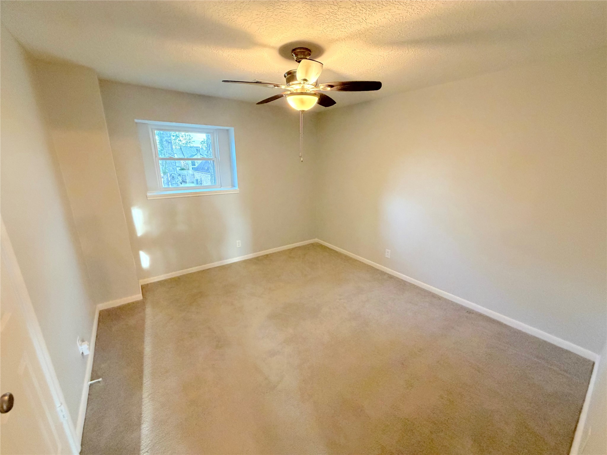 20723 Trellis Lane Houston, TX 77073 - Photo 21 of 29 an empty room with a chandelier fan and windows