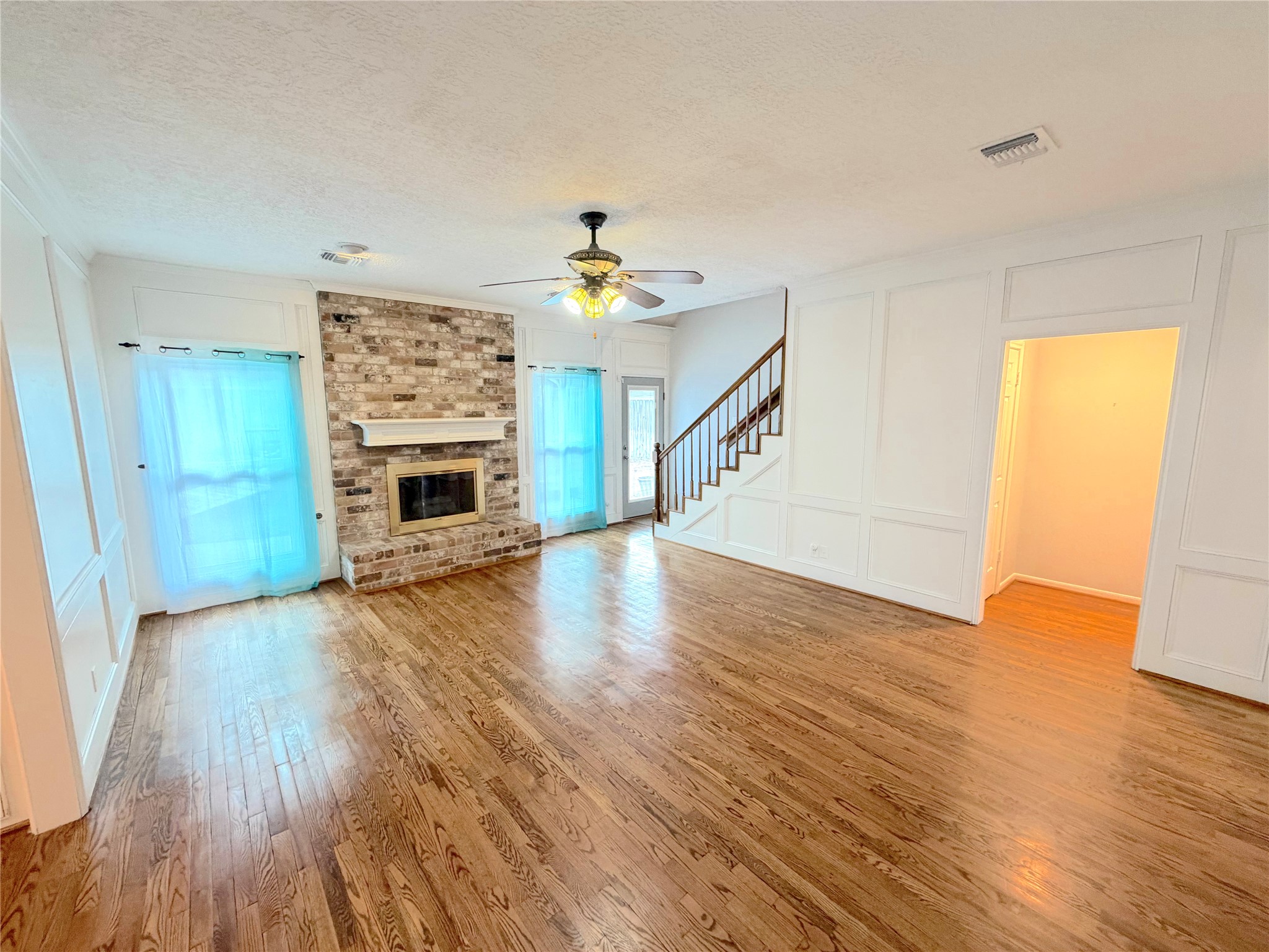20723 Trellis Lane Houston, TX 77073 - Photo 10 of 29 a view of an empty room with wooden floor fireplace and a window