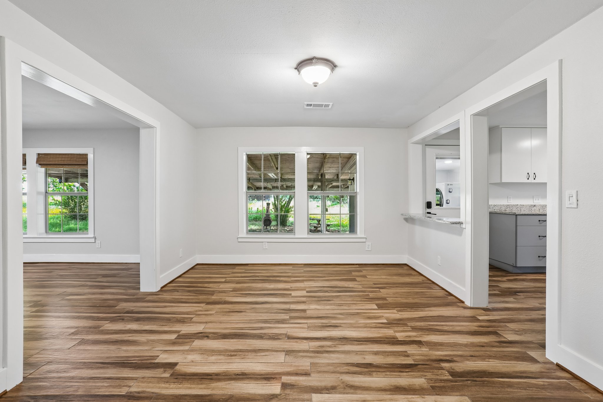 2089 Farm To Market Road 1704 Elgin, TX 78621 - Photo 7 of 31 A naturally illuminated living space offers an open layout and durable plank flooring.