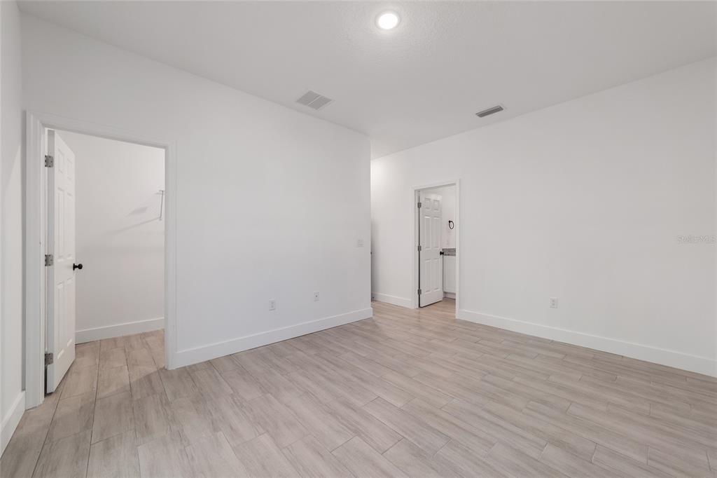 15431 Southwest 41st Street Road Ocala, FL 34481 - Photo 31 of 44 a view of an empty room with wooden floor and closet
