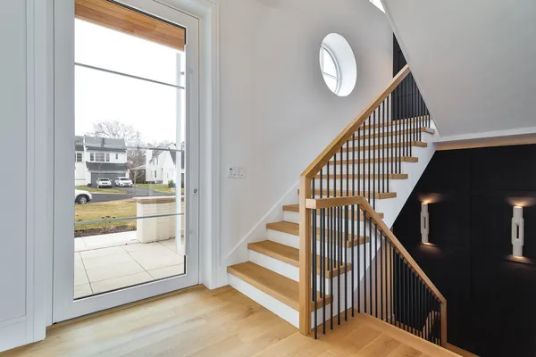 a view of entryway and hall with wooden floor