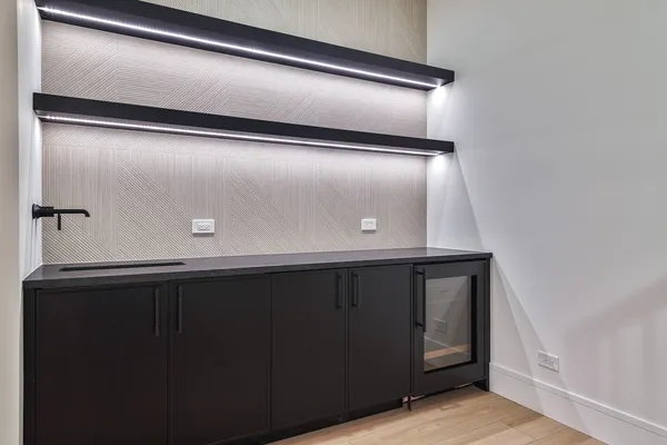 an empty room with wooden floor and window