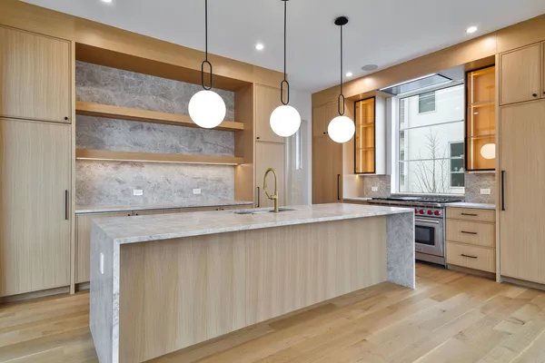 a large kitchen with a large window cabinets and stainless steel appliances