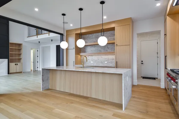 a view of a kitchen counter space a wooden floor and a window