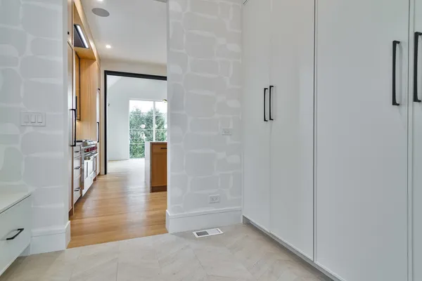a view of a hallway with wooden floor