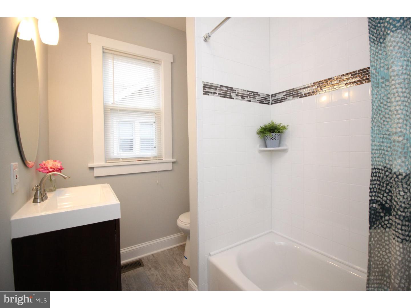 100 Princeton Road Audubon, NJ 08106 - Photo 12 of 20 a bathroom with a sink vanity mirror and a bathtub