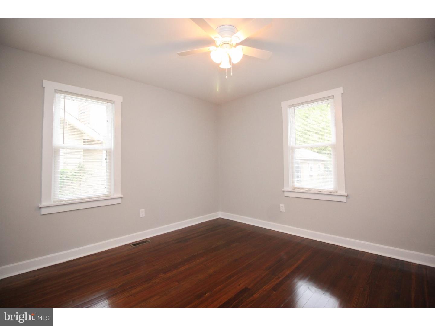 100 Princeton Road Audubon, NJ 08106 - Photo 13 of 20 an empty room with wooden floor and a window