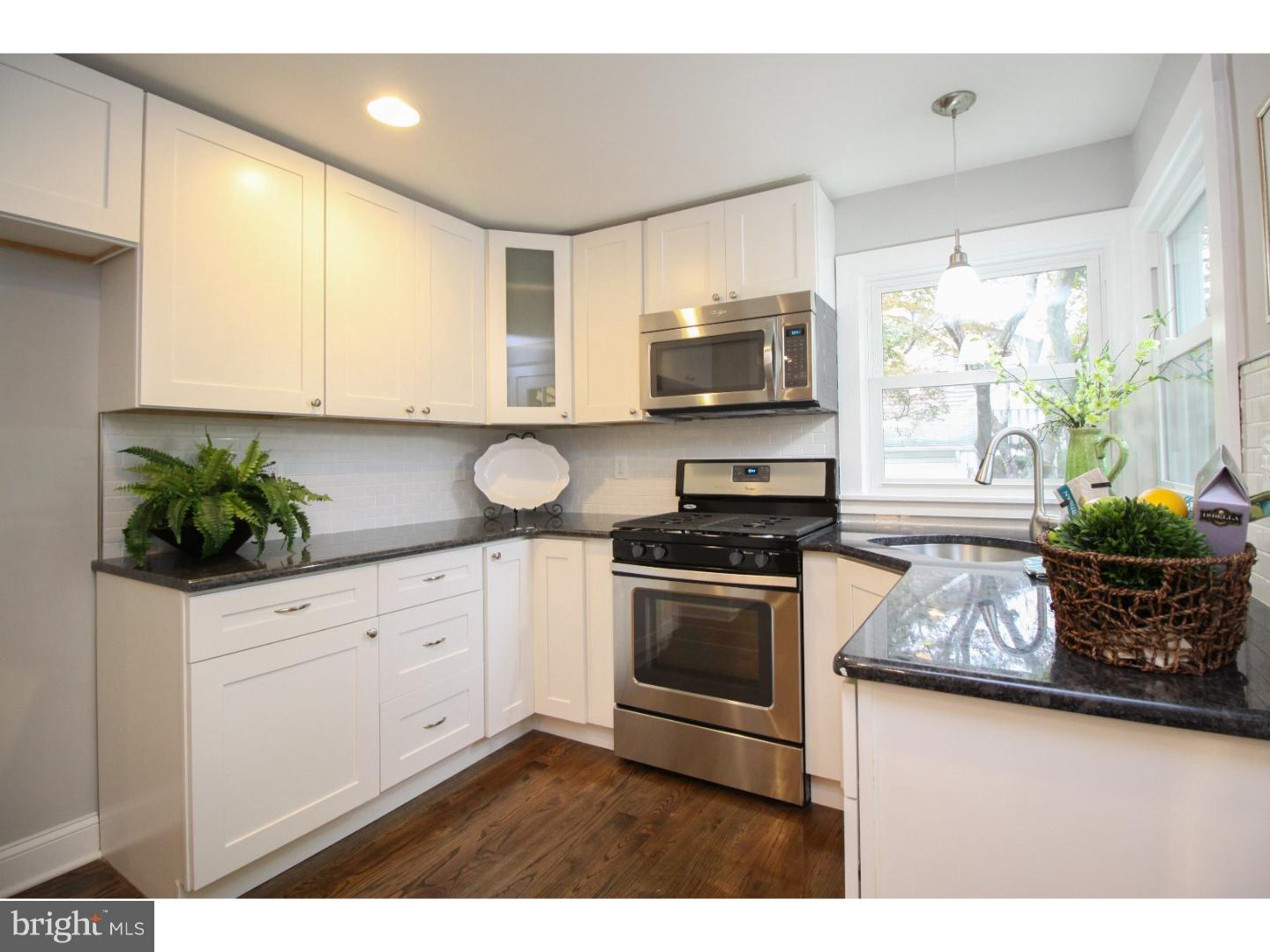 100 Princeton Road Audubon, NJ 08106 - Photo 8 of 20 a kitchen with stainless steel appliances white cabinets a stove a sink and a microwave