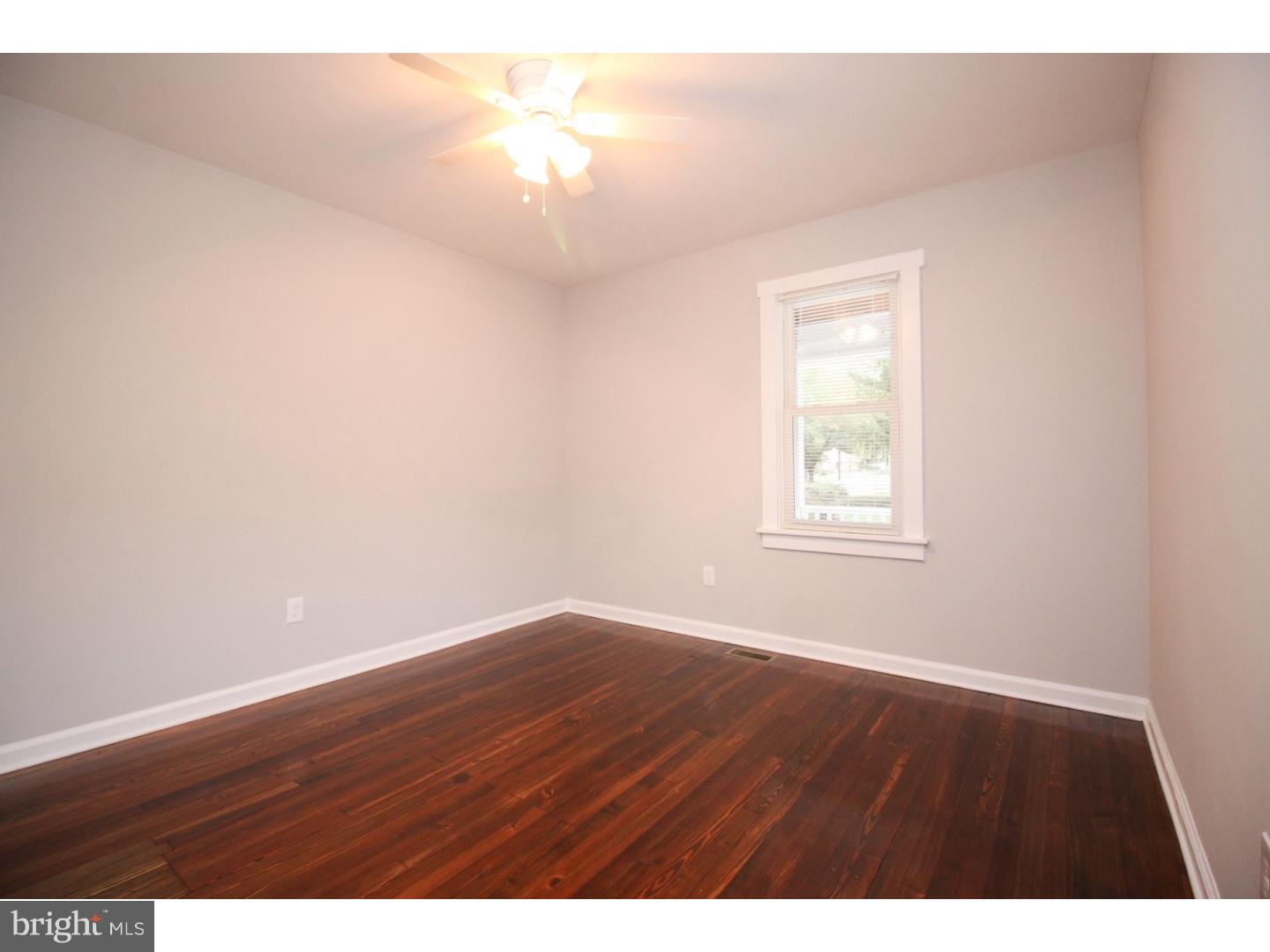100 Princeton Road Audubon, NJ 08106 - Photo 10 of 20 a view of an empty room with wooden floor and a window
