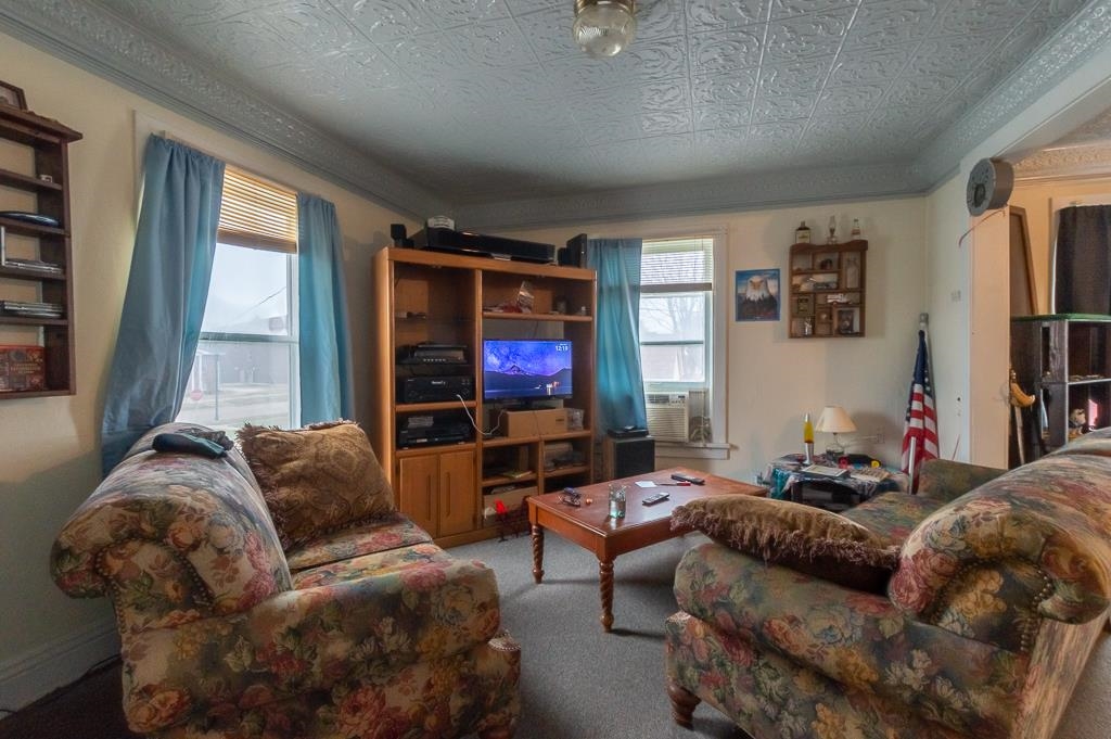 318 6th Avenue Rochelle, IL 61068 - Photo 2 of 11 a living room with furniture and a flat screen tv