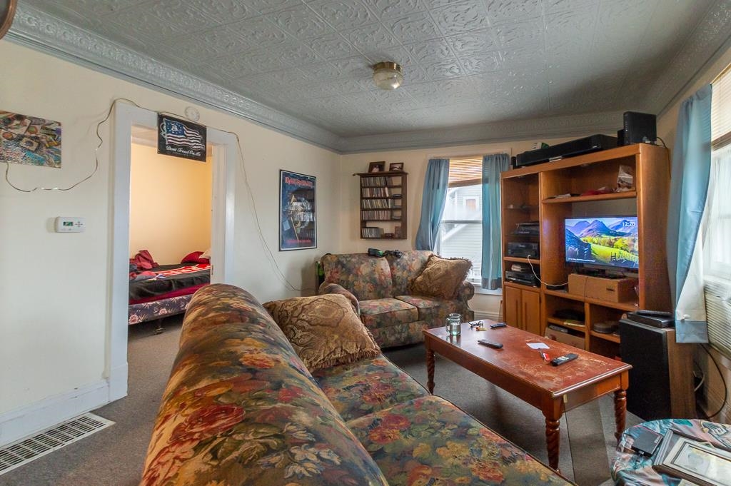 318 6th Avenue Rochelle, IL 61068 - Photo 3 of 11 a living room with furniture and a flat screen tv