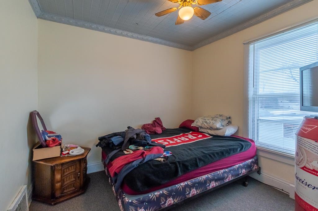 318 6th Avenue Rochelle, IL 61068 - Photo 5 of 11 a bedroom with a bed and a chandelier