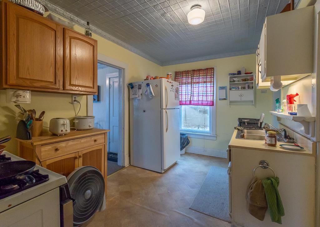 318 6th Avenue Rochelle, IL 61068 - Photo 7 of 11 a view of a kitchen with fridge and wooden floor