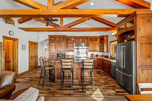 a kitchen with stainless steel appliances granite countertop a stove a sink and a microwave