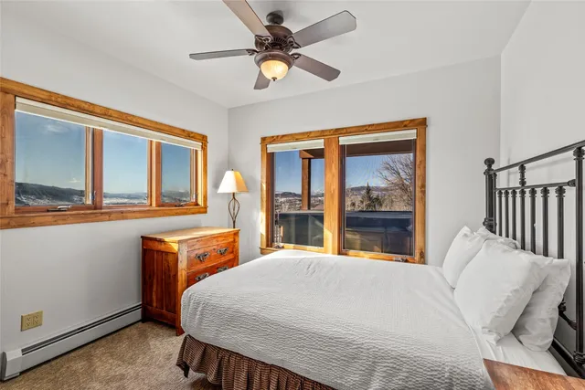 a bedroom with two beds and painting on the wall
