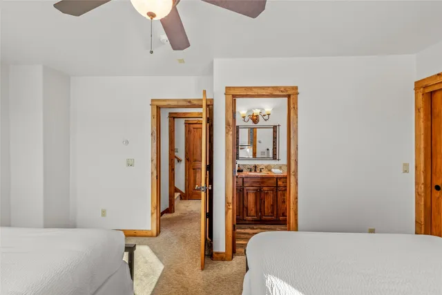 a spacious bedroom with a bed and a dresser