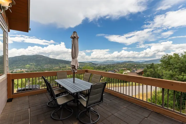 a view of a balcony with wooden floor and outdoor space