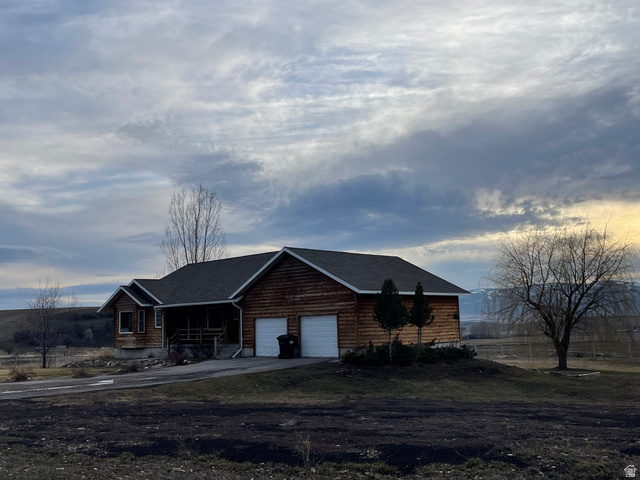 333 Lago Liberty Road Grace, ID 83241 - Photo 13 of 35 View of front of property with a porch, asphalt driveway, and an attached garage