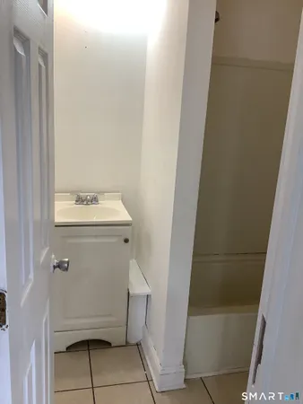 a white bath tub sitting next to a toilet