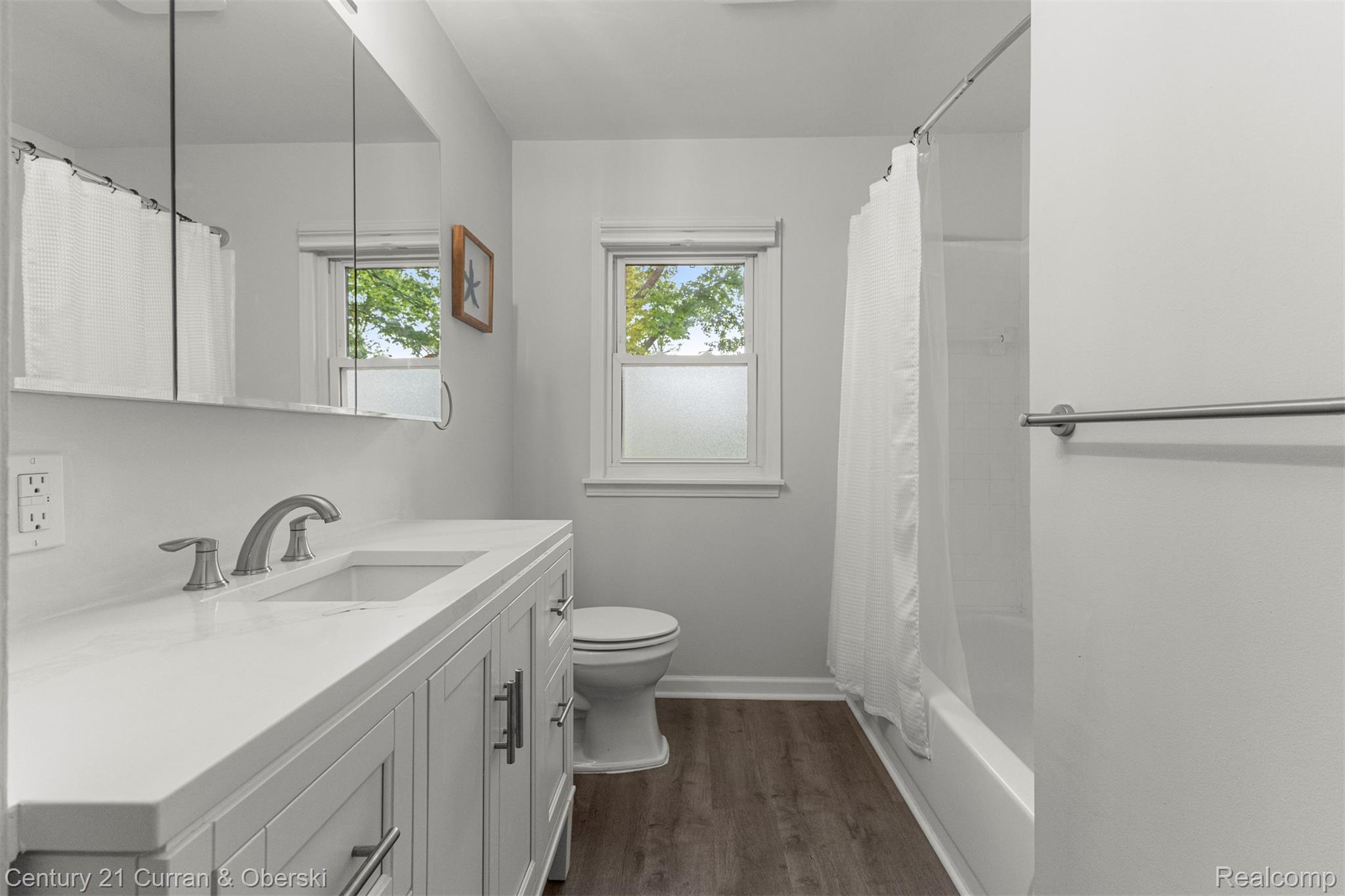 411 South Adrian Street Tecumseh, MI 49286 - Photo 21 of 61 Bathroom with vanity, dark wood-style floors, and shower / bath combo