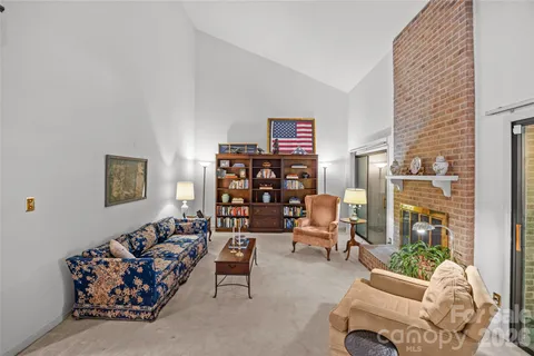 a living room with furniture a large window and a table