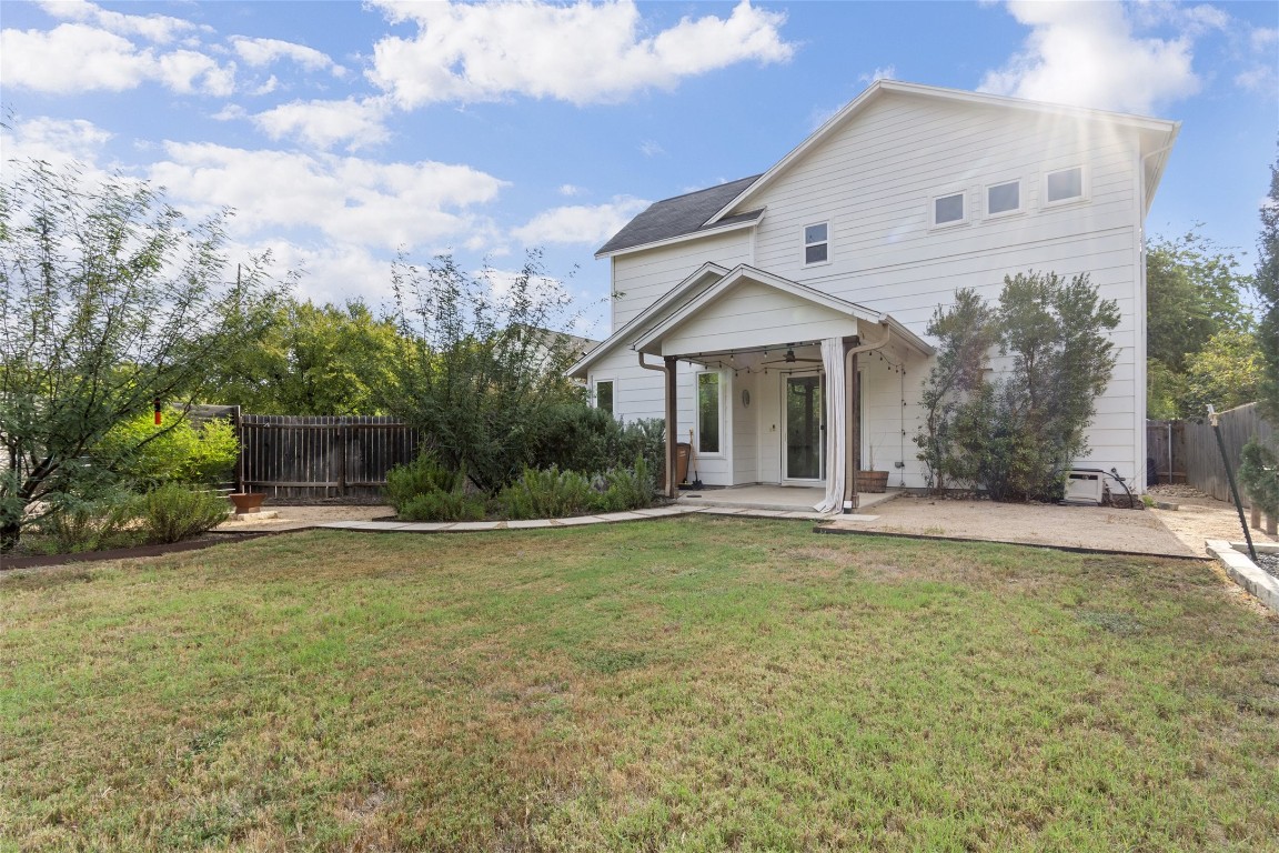 1145 Shady Lane, Unit 1A Austin, TX 78721 - Photo 21 of 25 Backyard & Covered Patio – Rarely found in East Austin, this expansive backyard offers multiple vignettes for entertaining, relaxing, or play. The covered patio creates a natural extension of the living space, surrounded by lush greenery and privacy.