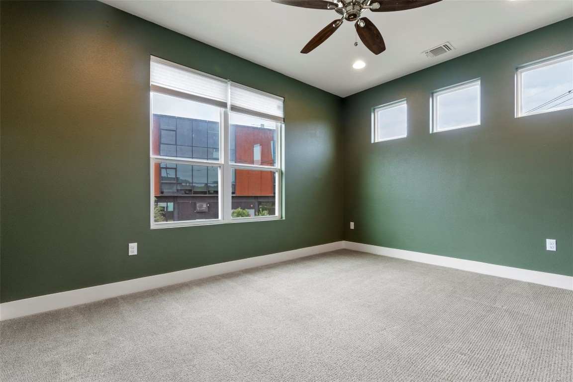 1145 Shady Lane, Unit 1A Austin, TX 78721 - Photo 4 of 25 Spacious primary suite with natural light and calming modern tones.