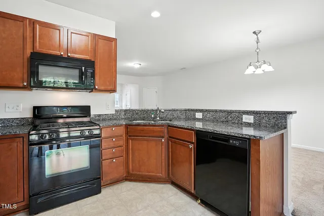 a kitchen with stainless steel appliances granite countertop a stove microwave and oven