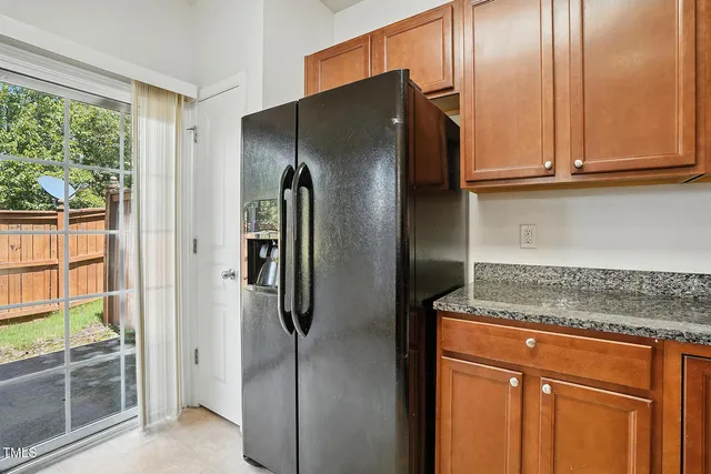 a kitchen with stainless steel appliances granite countertop a refrigerator and a sink