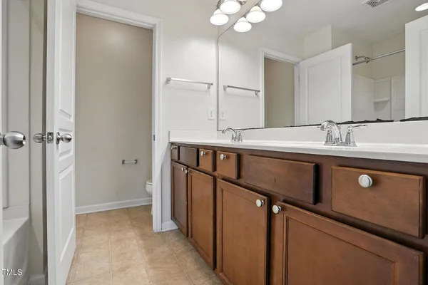 a bathroom with a sink a mirror and a shower