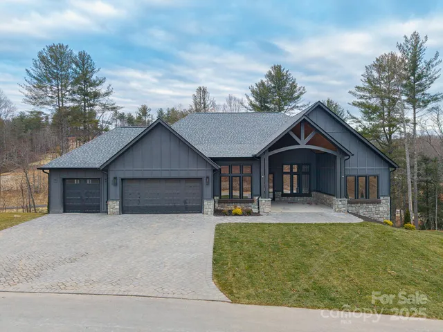 a front view of a house with yard and tress