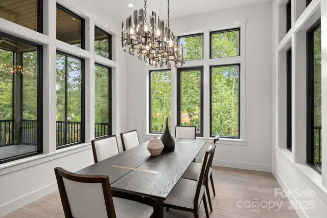 a living room with furniture a chandelier and a fireplace