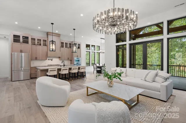 a living room with furniture and a chandelier