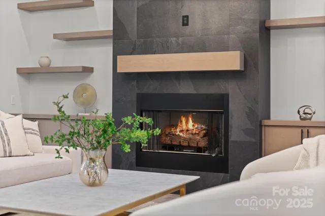 a living room with furniture and a chandelier