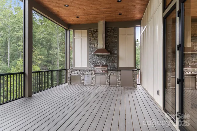 a view of balcony with wooden floor and fence