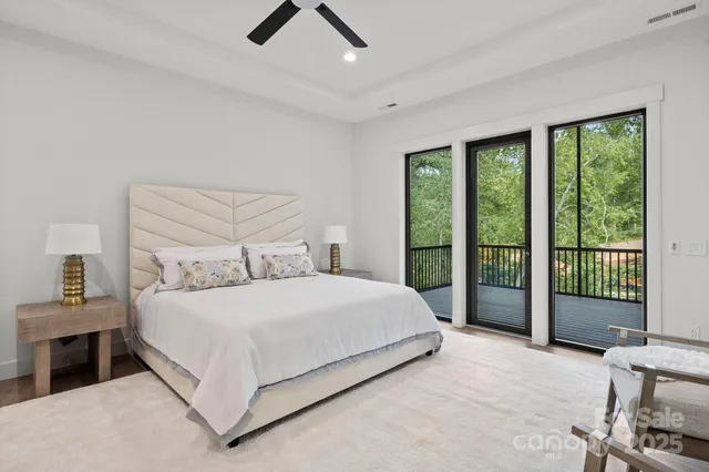 a bedroom with a large bed and a balcony view