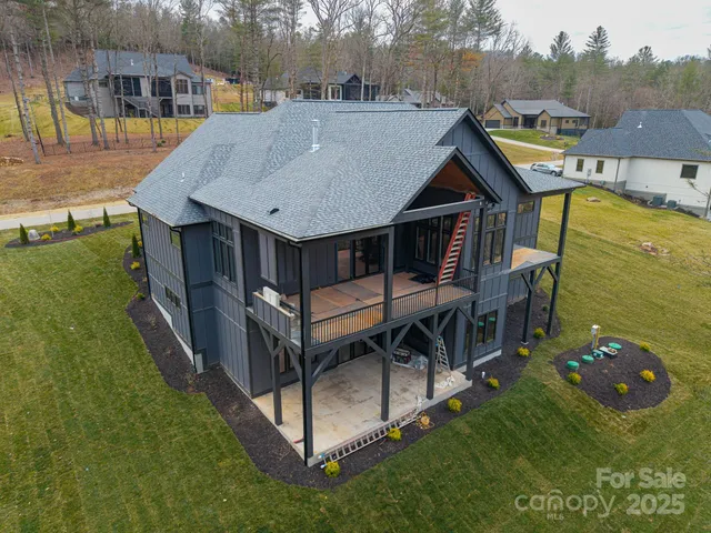 an aerial view of a house with swimming pool having outdoor seating