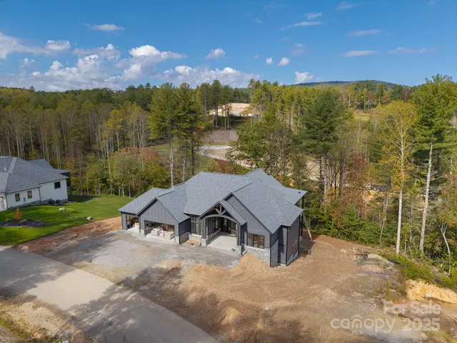 an aerial view of a house with swimming pool and sitting space