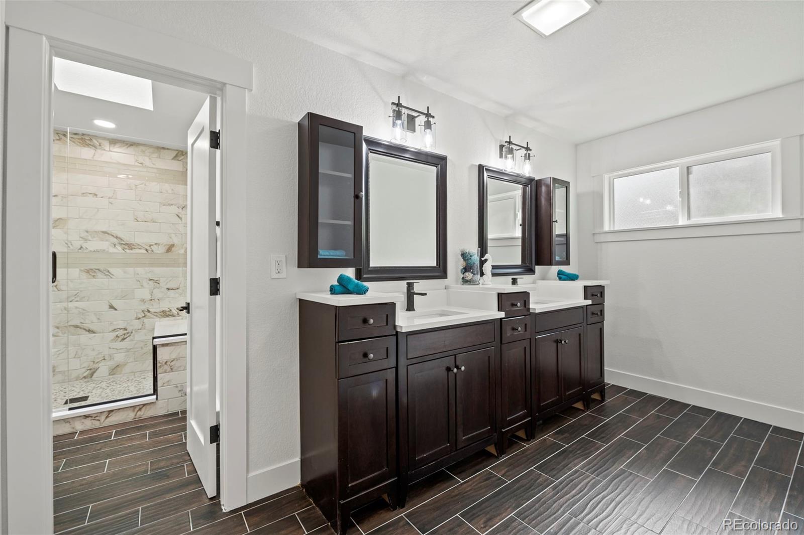 28877 Cedar Circle Evergreen, CO 80439 - Photo 14 of 30 a bathroom with double vanity and a mirror