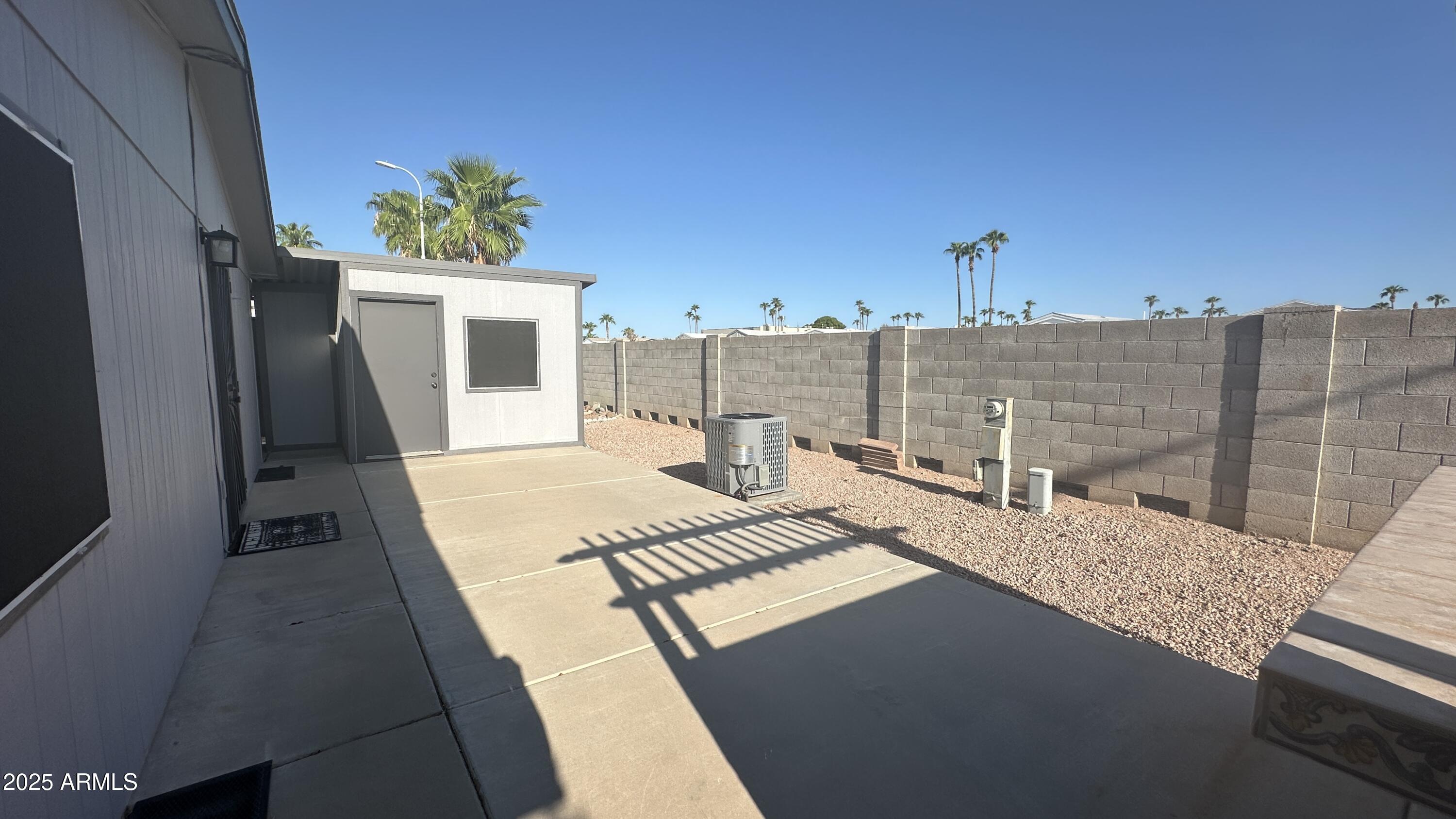 834 South Meridian Road, Unit 76 Apache Junction, AZ 85120 - Photo 12 of 50 a view of a terrace with wooden floor and a potted plant