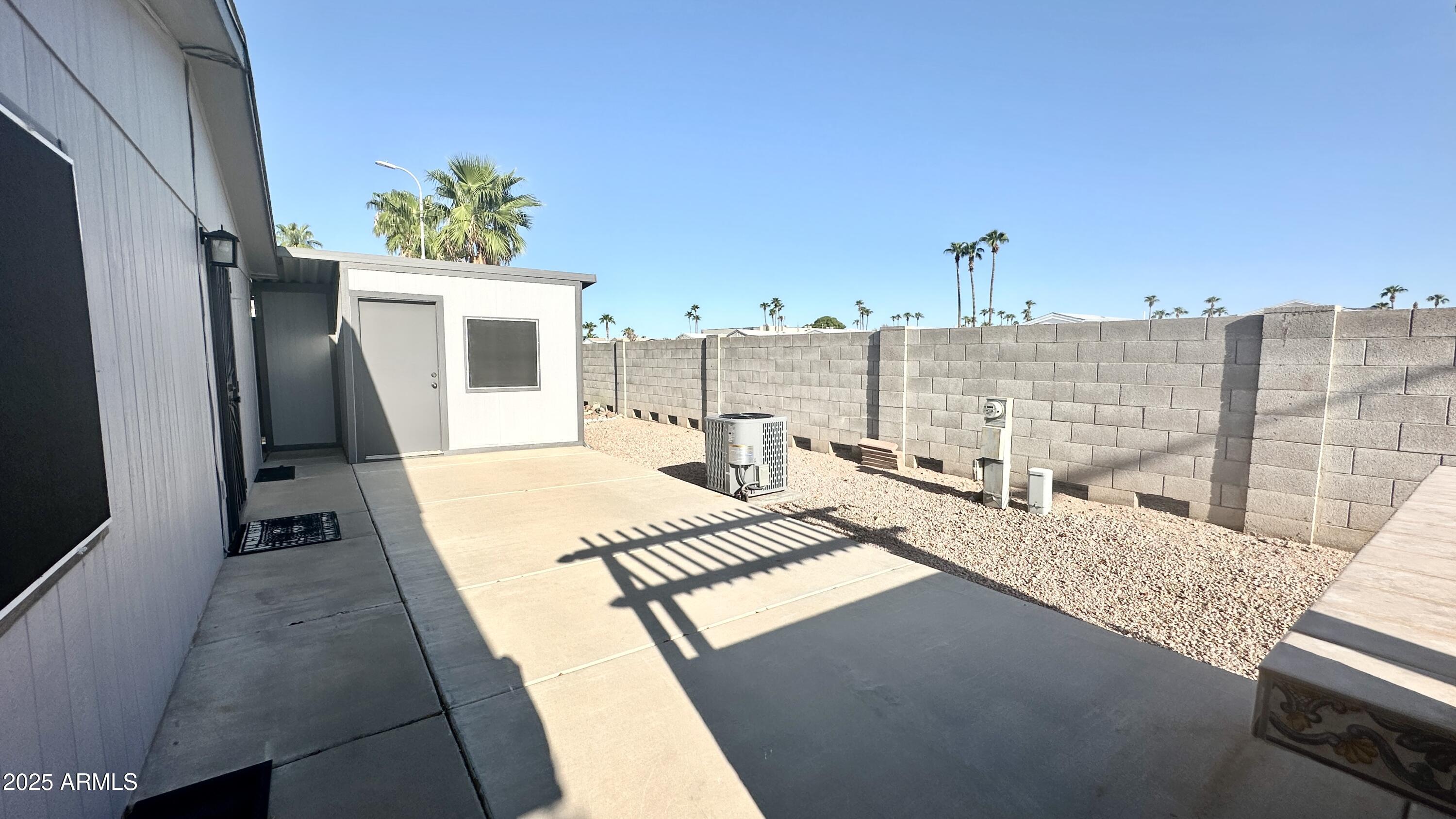 834 South Meridian Road, Unit 76 Apache Junction, AZ 85120 - Photo 18 of 50 a view of a balcony with furniture and a potted plant