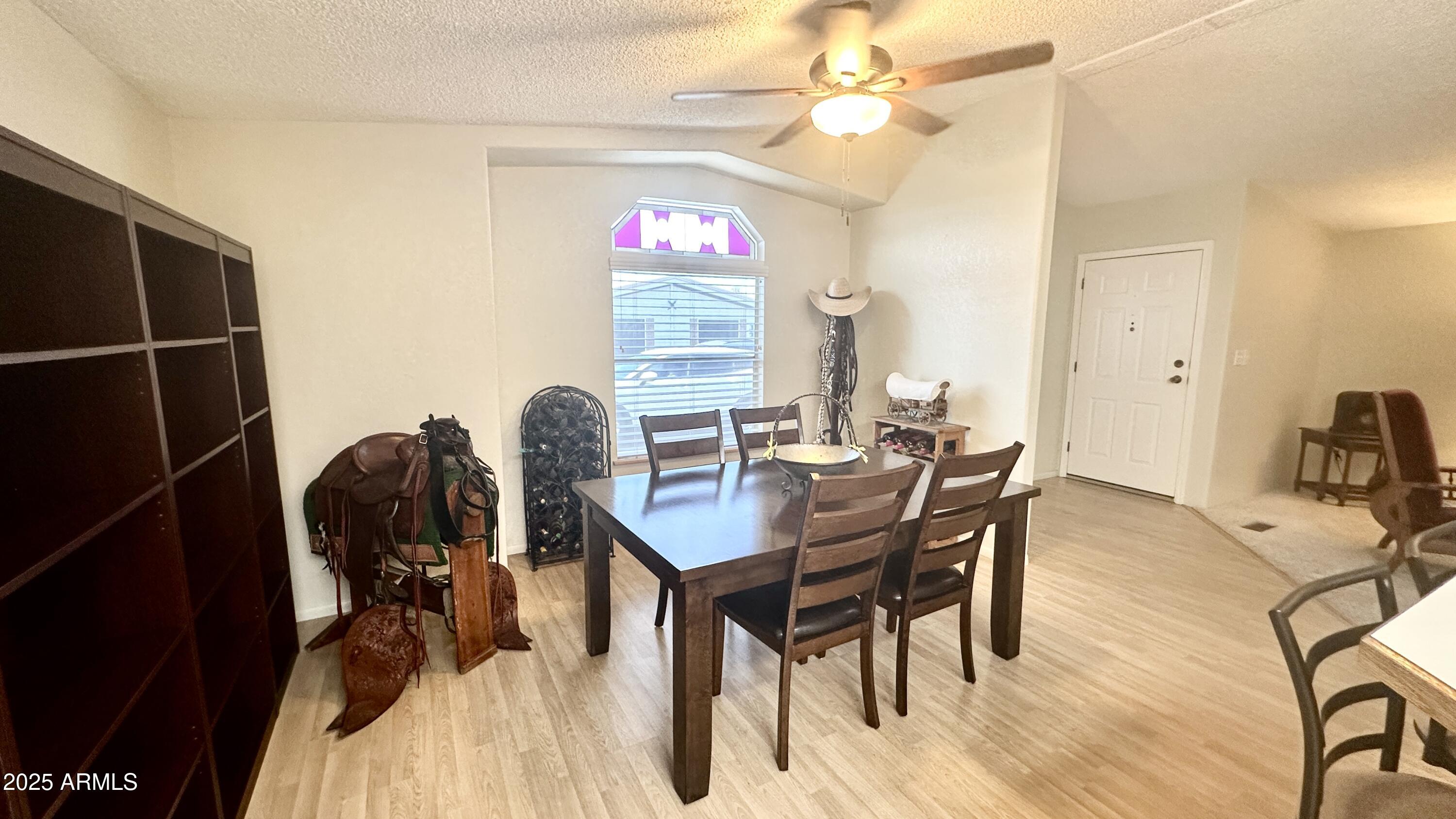 834 South Meridian Road, Unit 76 Apache Junction, AZ 85120 - Photo 24 of 50 a view of a dining room with furniture and chandelier