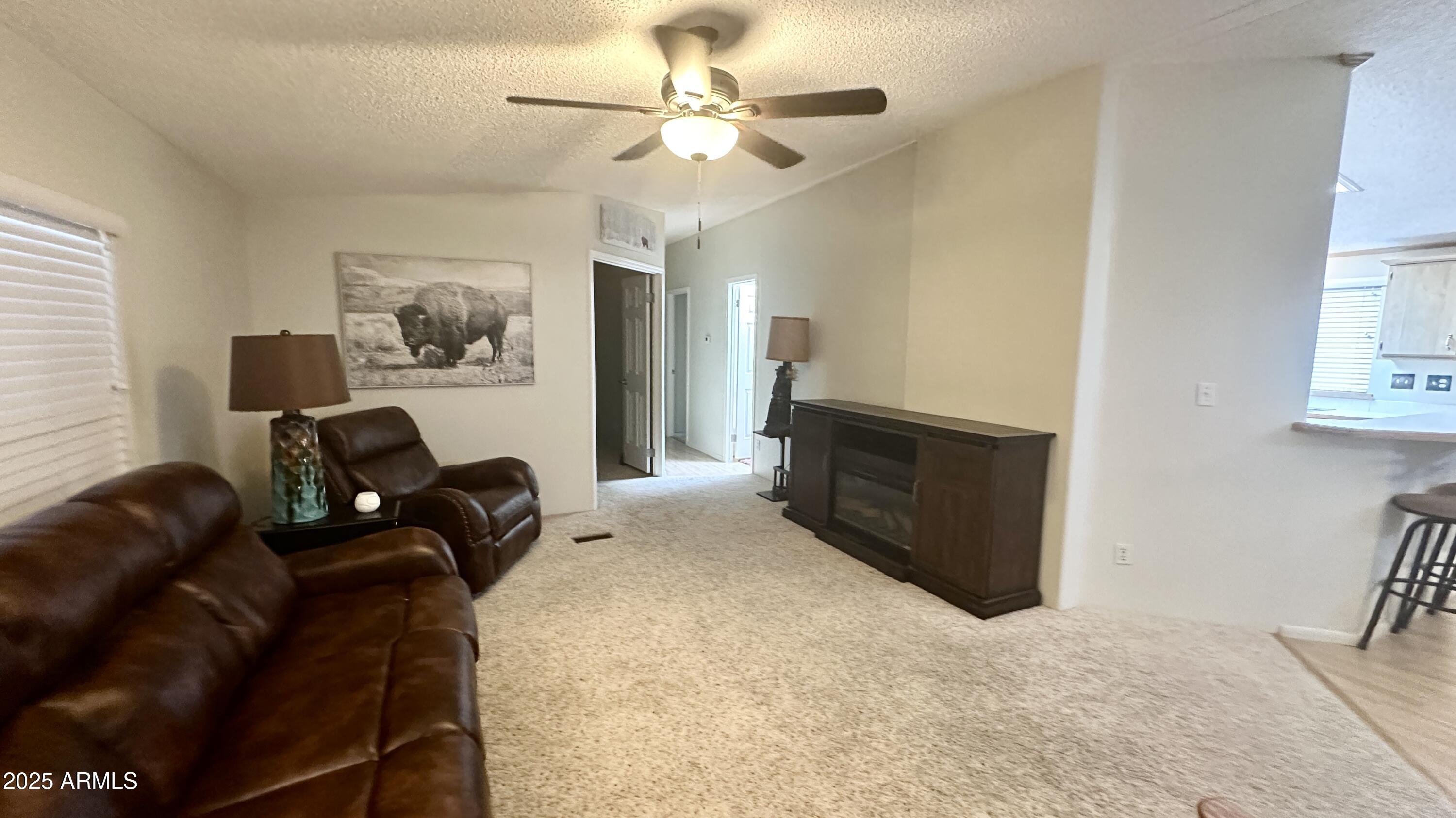 834 South Meridian Road, Unit 76 Apache Junction, AZ 85120 - Photo 26 of 50 a living room with furniture and a ceiling fan